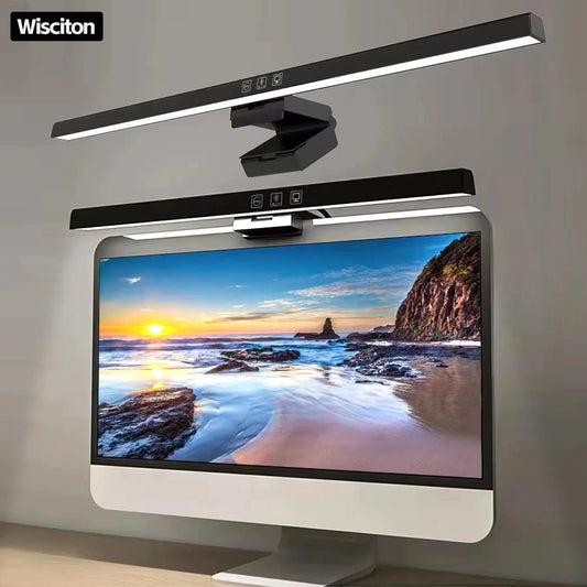 Computer monitor with a scenic display, flanked by two Wisciton desk lights on a neutral background.